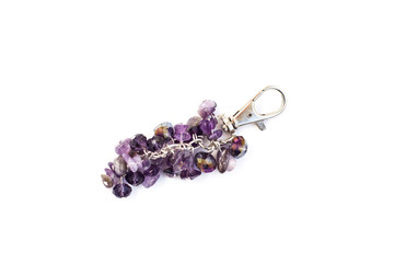 Keychain made with silver color metal, violet stones and crystals isolated on white background