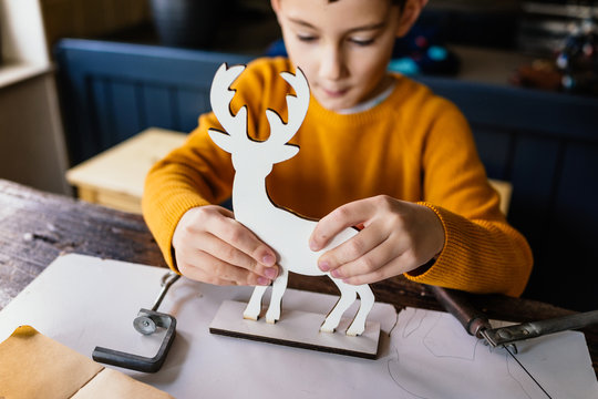 Making wooden deer figurine