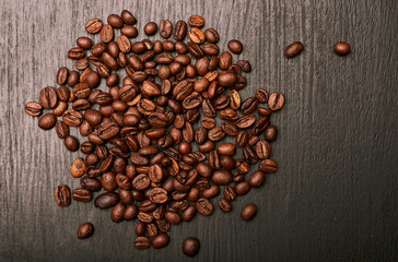 coffee beans in shape of heart on wooden background
