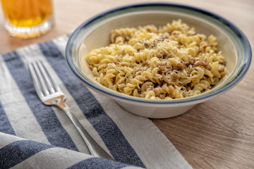 Pasta with cheese on a plate by the window