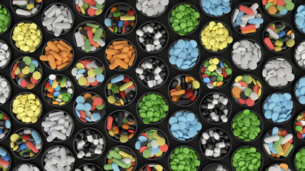 Colorful drug pills in lids