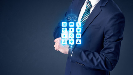 Businessman wearing smartwatch with application icons.