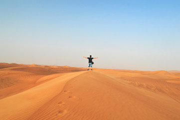 girl in the setting sun in the desert