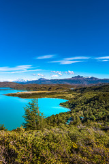 Fototapeta na wymiar View of Torres del Paine National Park, its forests, lagoon, glaciers and camping site, Patagonia, Chile, sunny day, blue sky