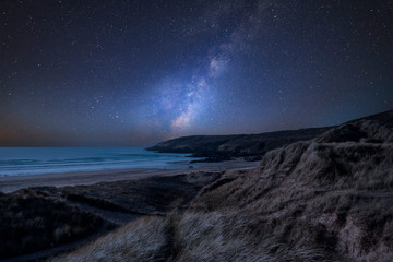 Fototapeta na wymiar Vibrant Milky Way composite image over landscape of Freshwater West beach in Pembrokeshire Wales
