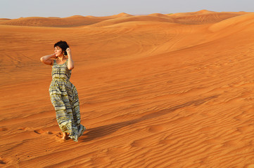 silhouette of a girl in the setting sun in the desert in the United Arab Emirates
