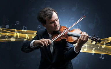 Young male musician playing on his violin with musical notes around