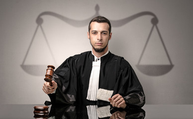Young handsome judge in black gown making decision