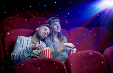 Lovely couple watching 3D movie with little sparkling stars around