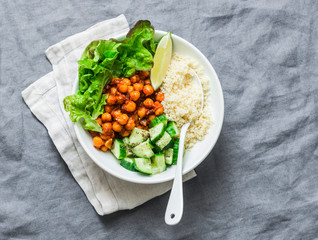 Detox moroccan spiced chickpea glow bowl on a grey background, top view. Vegetarian food concept