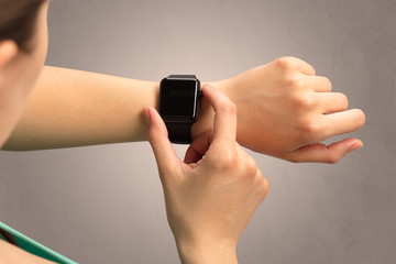Female hand with black screen smartwatch.