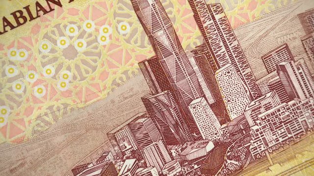 Saudi Arabia 10 riyal (2016) banknote rotating, King Abdullah Financial Center in Riyadh, Saudi Arabian currency close up. 4K UHD video footage