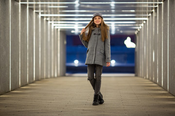 Full-length photo of girl in gray coat standing