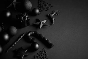Christmas minimalistic and simple composition in mat black color. Christmas gifts, decorations on...