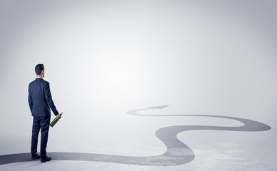 Fototapeta premium Man with object in his hand on the direct way to success