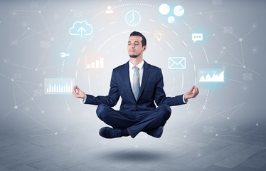 Elegant calm businessman levitates in yoga position with data circulation concept
