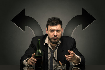 Drunk disappointed man sitting at table with arrows around
