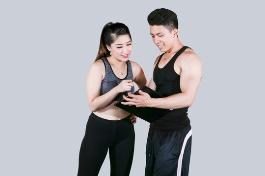 Woman and trainer looking at a clipboard