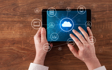 Hand touching tablet with cloud computing and online storage concept
