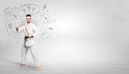 Fototapeta na wymiar Young kung-fu trainer fighting with doodled symbols concept 
