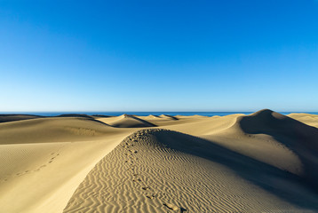 Fototapeta na wymiar View to Sand Dunes of Maspalomas at Gran Canary with the View to Atlantic Ocean / Spain