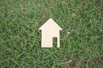 model of wood house on grass.