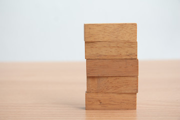 Stack of wooden block on table.