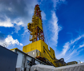 new drilling rig on the background of beautiful clouds