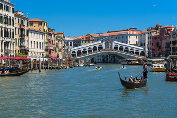 Fototapeta na wymiar The Grand Canal, gondola and Rialto bridge in Venice, Italy