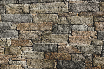 Old urban gray and brown natural rock bricks wall background of city building. Irregular stone brick historical surface