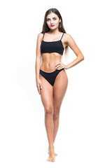 Obraz premium Full height of Gorgeous woman in black bikini against white background