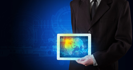 Hand holding tablet with global database concept
