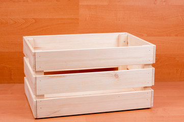 Wooden crate close up on brown floor background