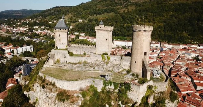 Aerial view of impressive medieval castle on rocky outcrop in French commune of Foix