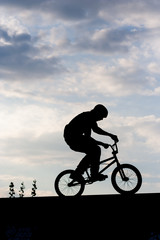 Silhouette of man riding bike