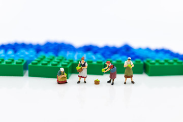 Miniature people: Gardeners and the results of agriculture, vegetables. Image use for distribution to the market.