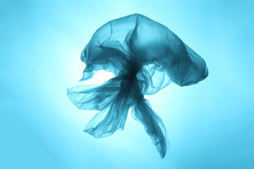 Plastic trash in the oceans of the planet. Ocean blue jellyfish from a plastic bag. The destruction...