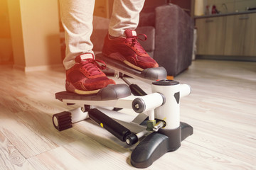 feet of a young woman on stepper, sport at home