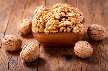  bowl of walnuts kernels and whole walnuts