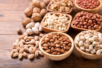 bowls of nuts on wooden table