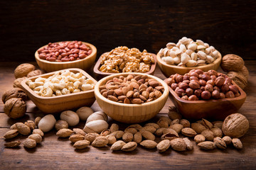 bowls of nuts on wooden table