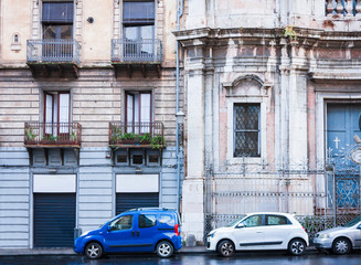 Fototapeta na wymiar Travel to Italy - historical street of Catania, Sicily, balcony on ancient building
