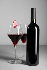 Decorating a bottle of red wine for Christmas.