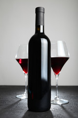 Old bottle of red wine. Alcoholic drink.