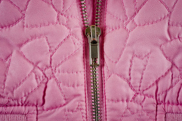Zipper on pink balon jacket close-up shot © Pavlo
