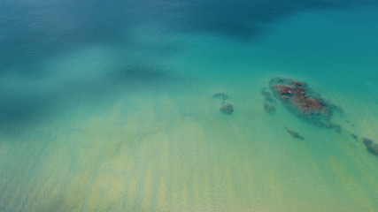 Aerial drone top view of transparent shallow water and sea ocean surface