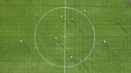 Amateur Soccer match kick off - Top down aerial footage.