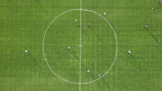 Amateur Soccer match kick off - Top down aerial footage.