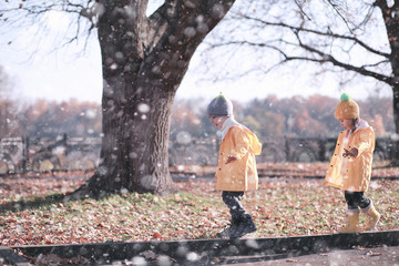 Kids walk in the park first snow