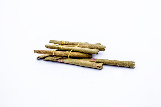 Close up of bidi or thin cigar or small cigarette isolated on white.